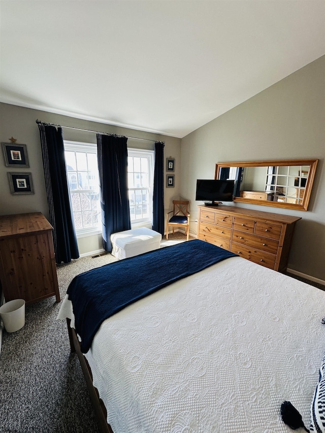 carpeted bedroom with lofted ceiling and visible vents