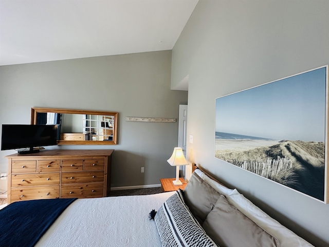 bedroom featuring carpet flooring, vaulted ceiling, and baseboards