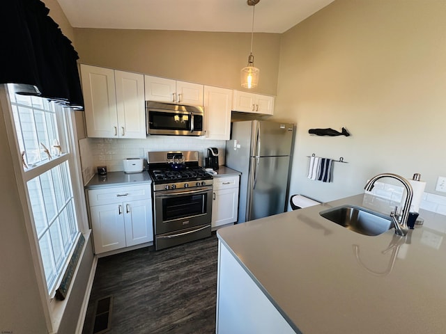 kitchen with white cabinetry, appliances with stainless steel finishes, light countertops, and a sink