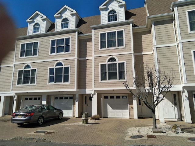 view of property featuring driveway and an attached garage