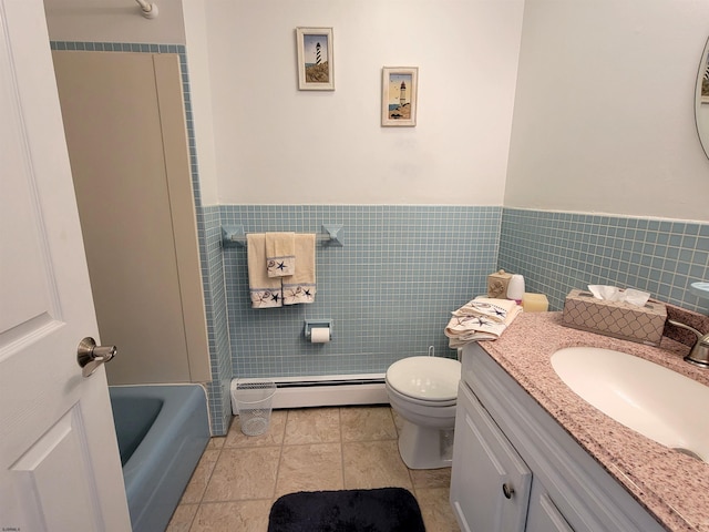 bathroom featuring tile walls, toilet, a bathing tub, a baseboard heating unit, and tile patterned floors