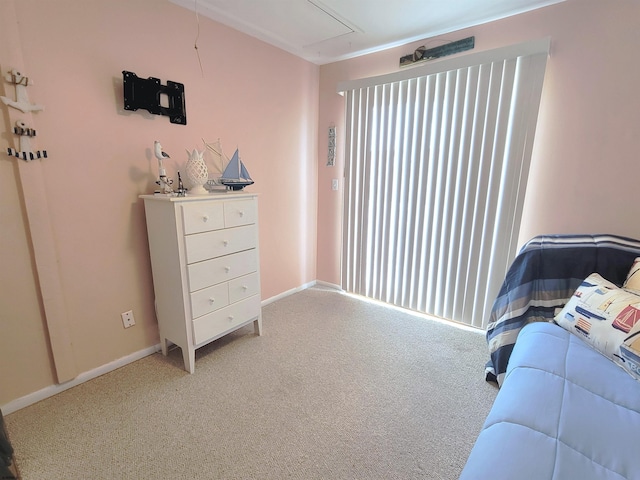 bedroom with multiple windows, carpet, attic access, and baseboards