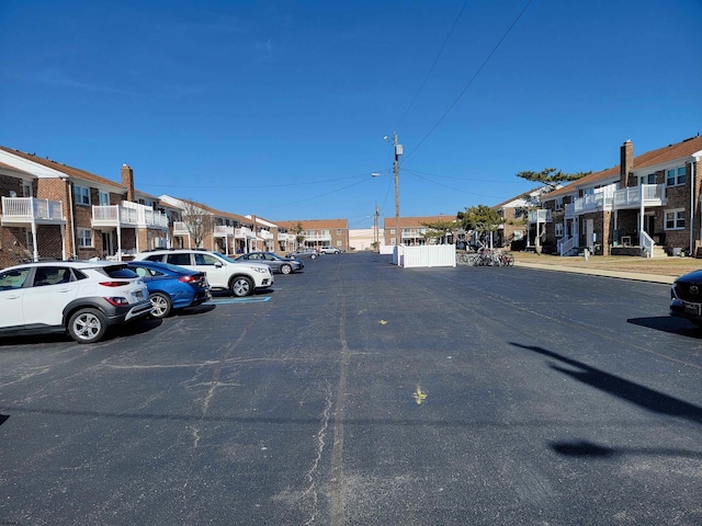 uncovered parking lot featuring a residential view