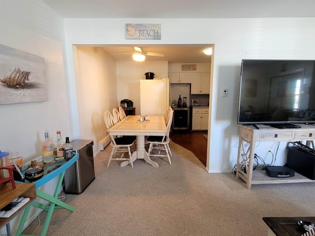 dining area with carpet floors and baseboards