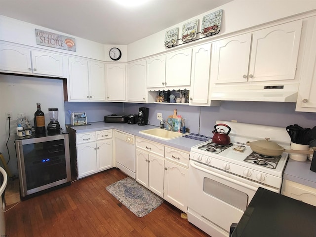 kitchen featuring white cabinetry, a sink, beverage cooler, white appliances, and under cabinet range hood