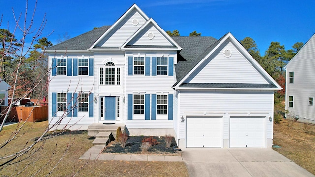 view of front of property featuring a shingled roof, fence, a garage, driveway, and a front lawn