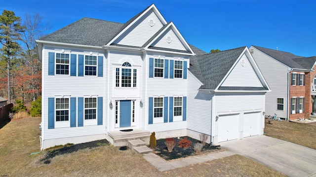 view of front of home with a garage, a front yard, driveway, and a shingled roof