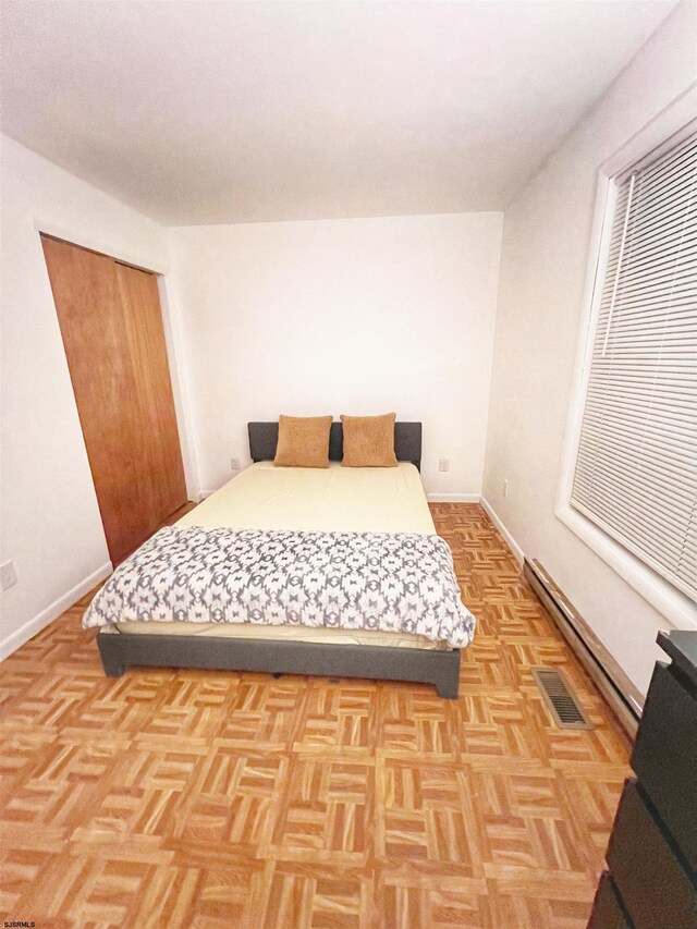 bedroom featuring baseboards and visible vents