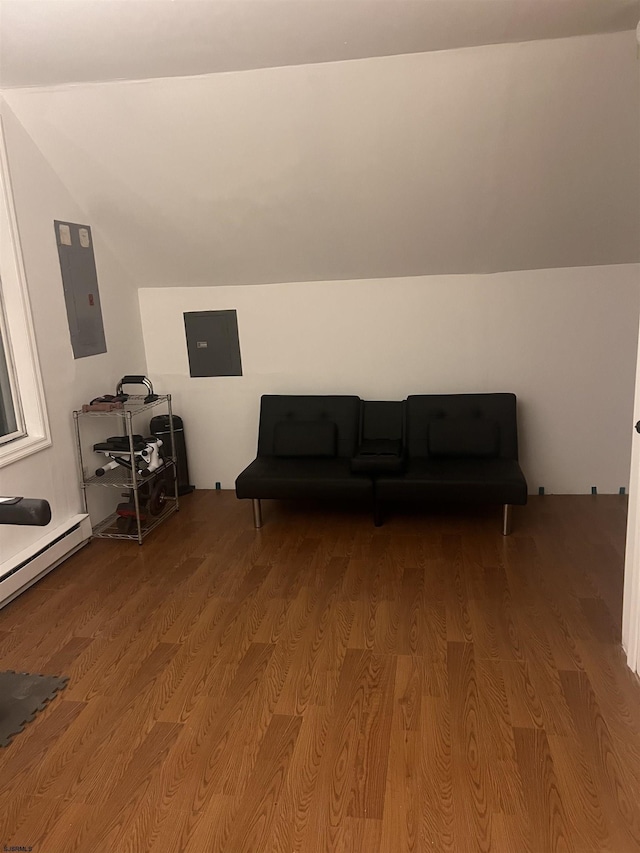 bonus room with vaulted ceiling, a baseboard heating unit, wood finished floors, and electric panel