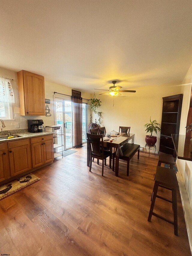 dining area featuring ceiling fan and wood finished floors