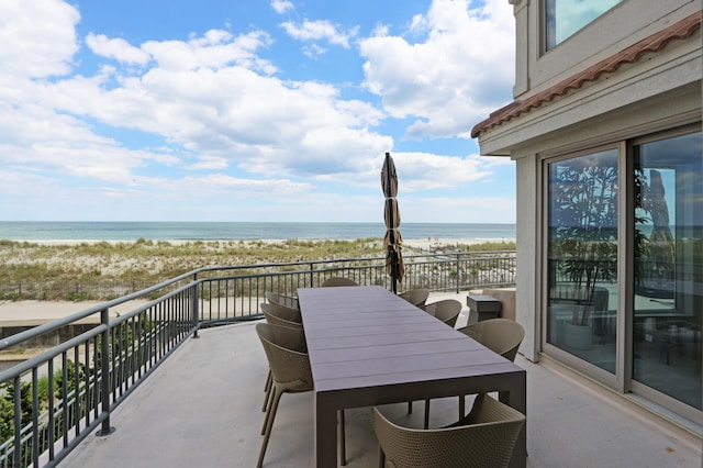 balcony with a view of the beach and a water view