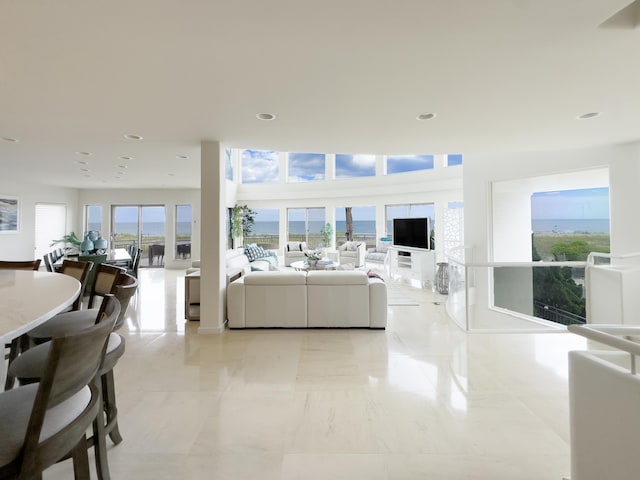 living room featuring marble finish floor and recessed lighting