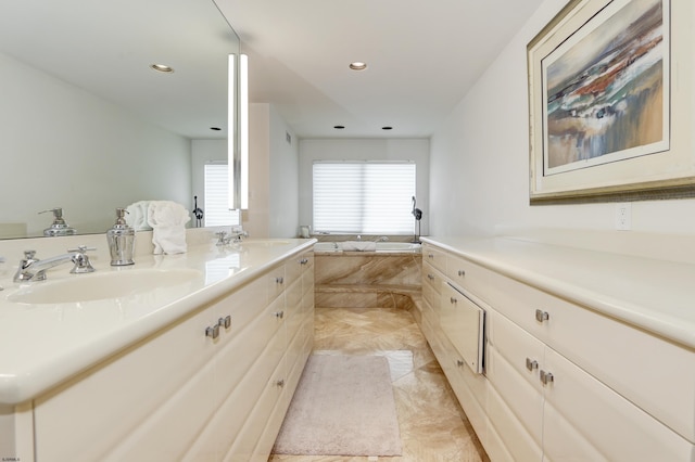 full bathroom featuring a garden tub, double vanity, a sink, and recessed lighting