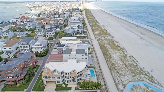 aerial view with a water view and a beach view