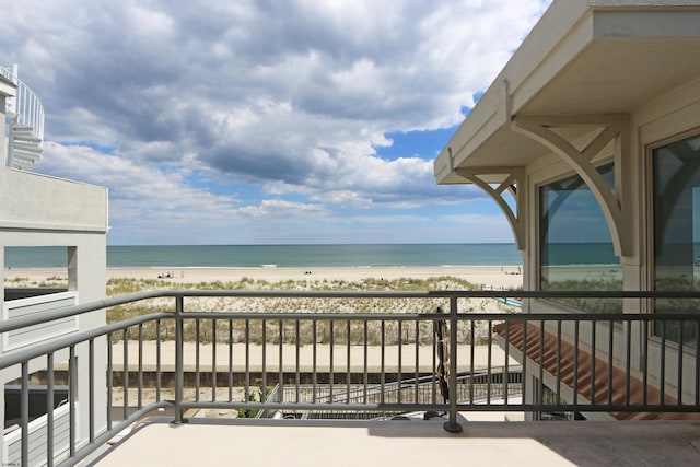 balcony with a beach view and a water view