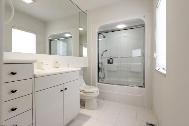 full bath with visible vents, toilet, tile patterned floors, combined bath / shower with glass door, and vanity