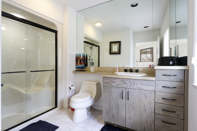 full bathroom with toilet, a shower stall, vanity, and tile patterned floors