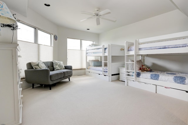 bedroom featuring light carpet and ceiling fan