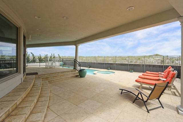 view of patio featuring a fenced in pool, a fenced backyard, and an in ground hot tub