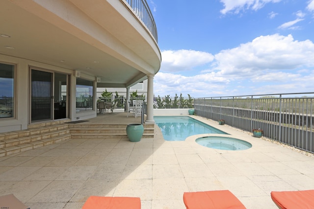 view of swimming pool featuring an in ground hot tub, a patio, and fence