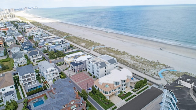 birds eye view of property with a water view and a view of the beach