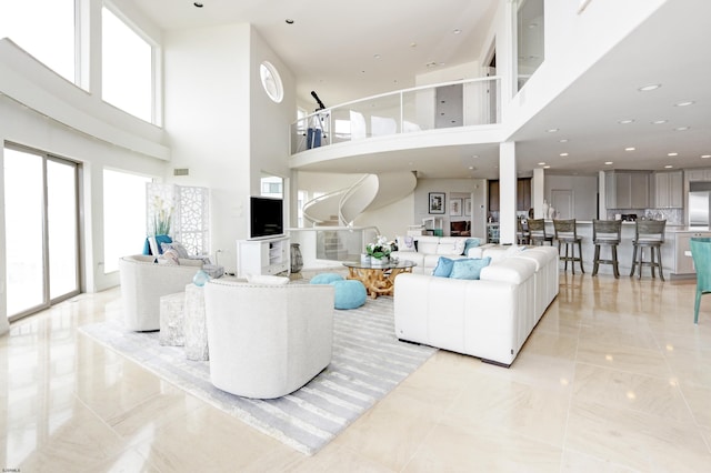 living room featuring recessed lighting, marble finish floor, and visible vents