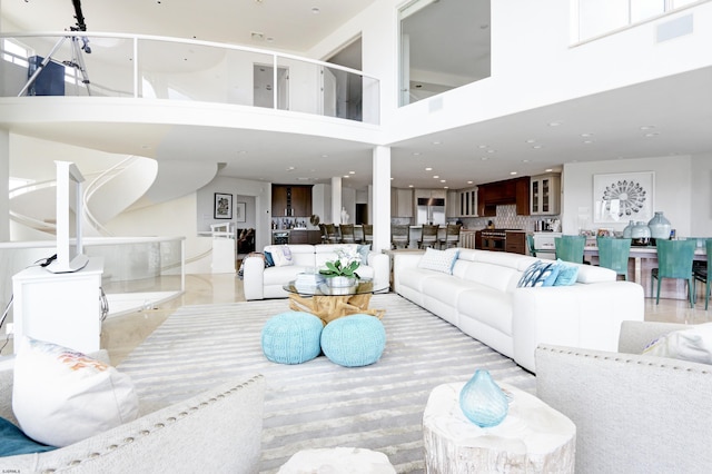 living area featuring visible vents and a towering ceiling