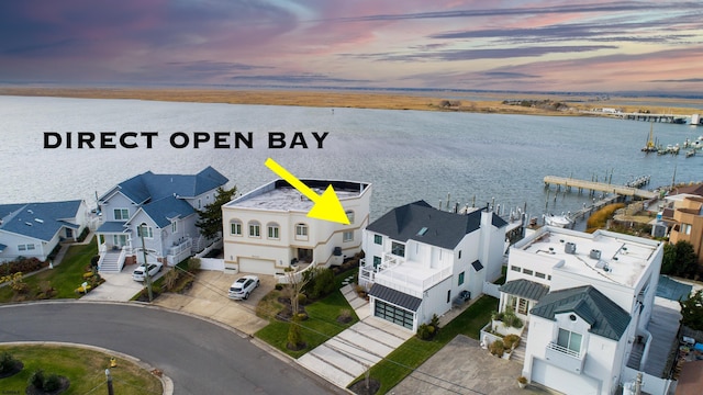 bird's eye view featuring a water view and a residential view