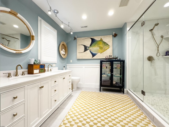 full bath with double vanity, a stall shower, visible vents, and a sink