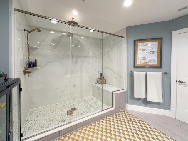 full bath with recessed lighting, visible vents, a marble finish shower, and tile patterned floors