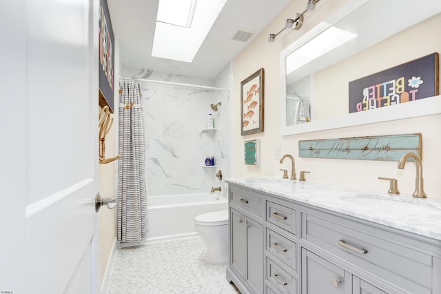 bathroom featuring double vanity, shower / tub combo, a skylight, visible vents, and a sink