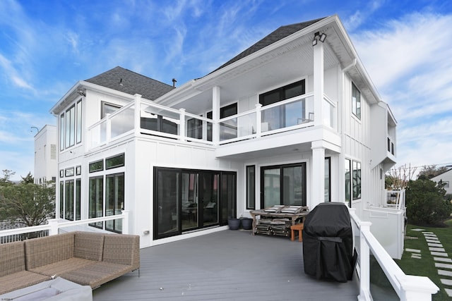 rear view of property with a balcony, an outdoor hangout area, roof with shingles, a deck, and board and batten siding