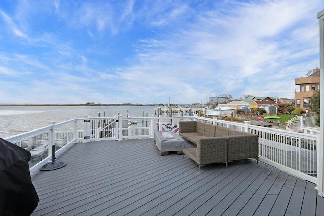 wooden terrace with a water view and an outdoor hangout area