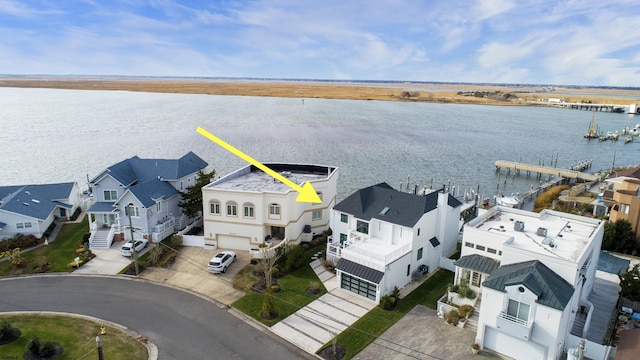 birds eye view of property with a water view and a residential view