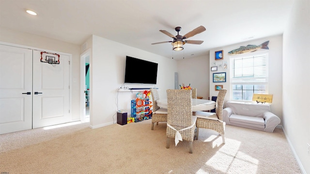 interior space with carpet, ceiling fan, and baseboards