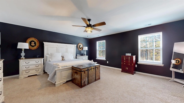 bedroom with multiple windows, light colored carpet, visible vents, and baseboards