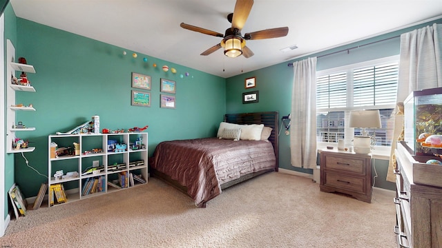 bedroom featuring ceiling fan, visible vents, baseboards, and light colored carpet