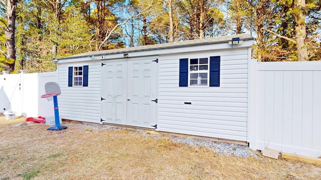 view of shed featuring fence