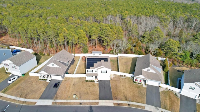 drone / aerial view featuring a forest view and a residential view