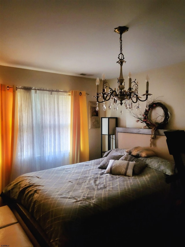 bedroom with a notable chandelier