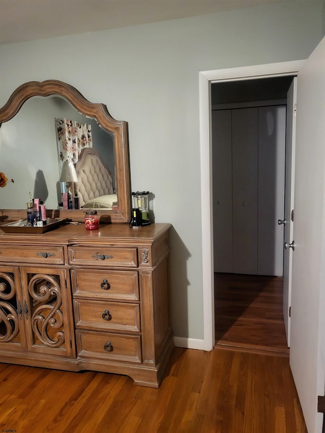 hall with dark wood-style floors and baseboards