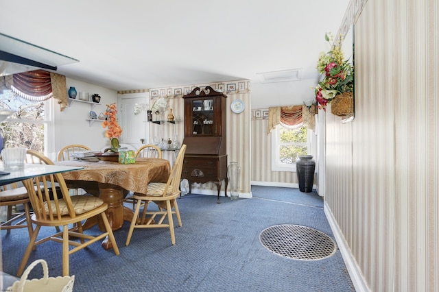 dining area with carpet and baseboards