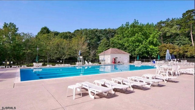 pool with fence and a patio