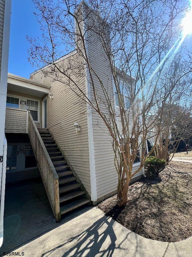 view of side of property featuring stairs