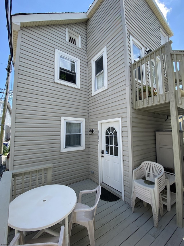 back of house featuring a wooden deck