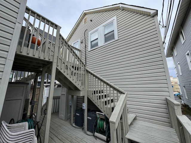 view of home's exterior with a wooden deck and stairs