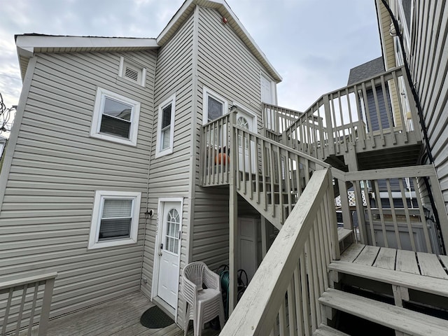 back of house with a deck and stairway