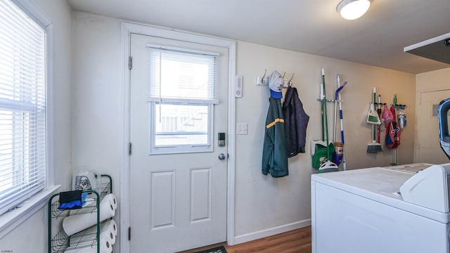 laundry room with washer / clothes dryer, laundry area, baseboards, and wood finished floors