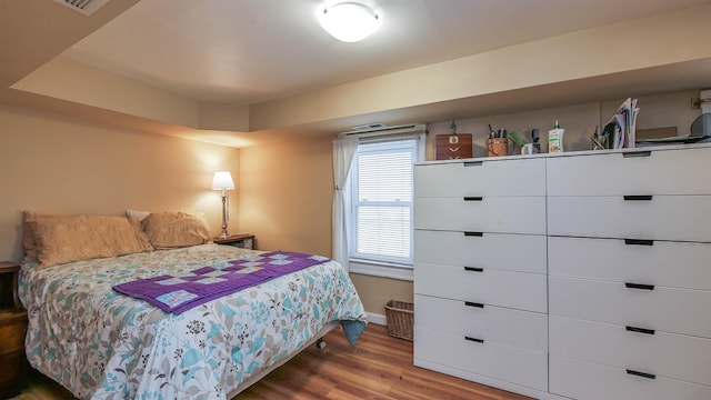 bedroom with baseboards and wood finished floors