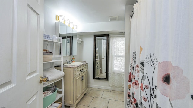 bathroom featuring a shower with curtain, vanity, visible vents, and tile patterned floors